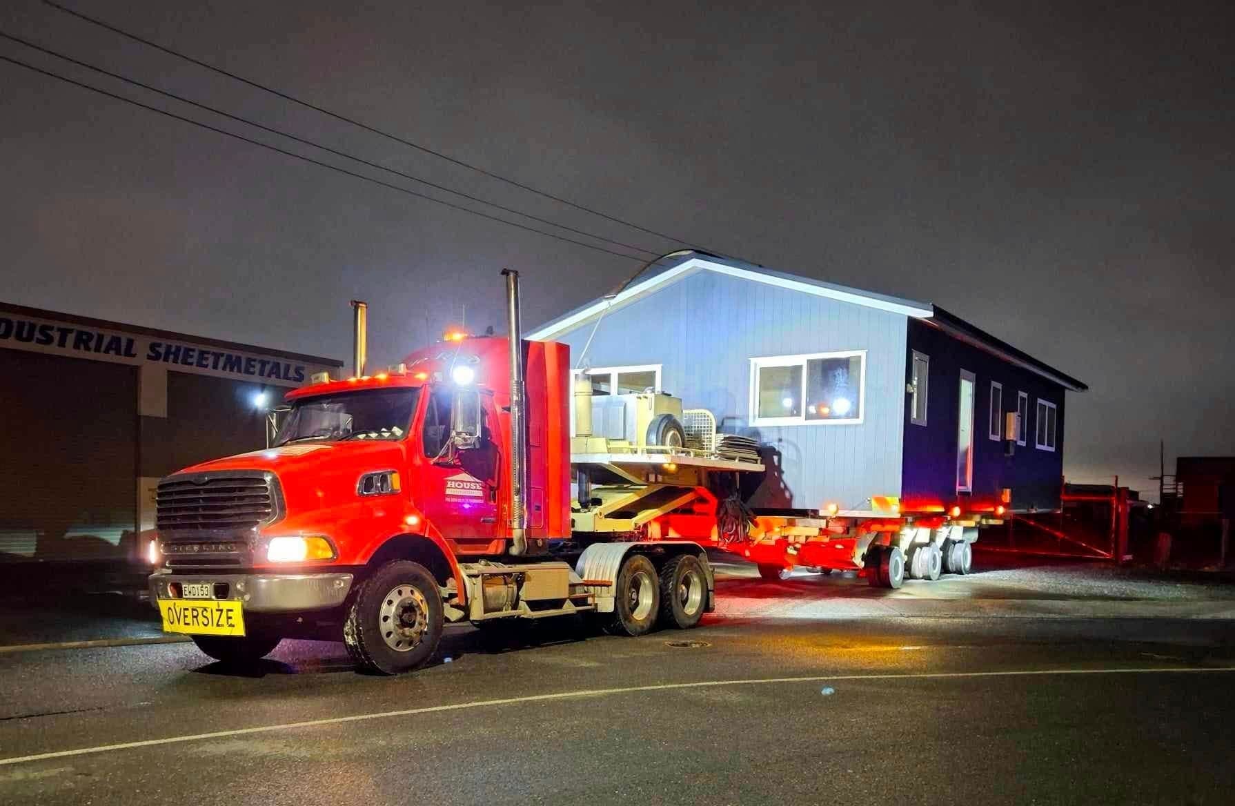 House Transporters truck carrying a house through NZ countryside